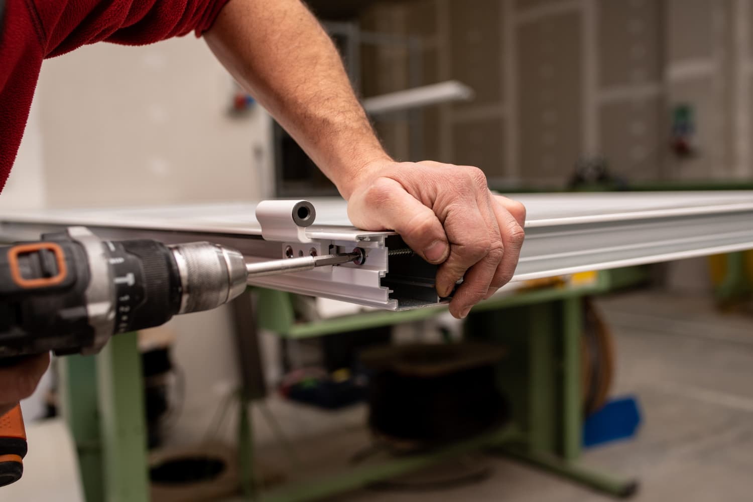 FeneFAB team member fabricating aluminum framing